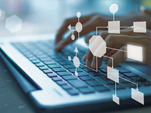 Person typing on a laptop with an overlay of interconnected network nodes and flowchart blocks representing data flow or processes.